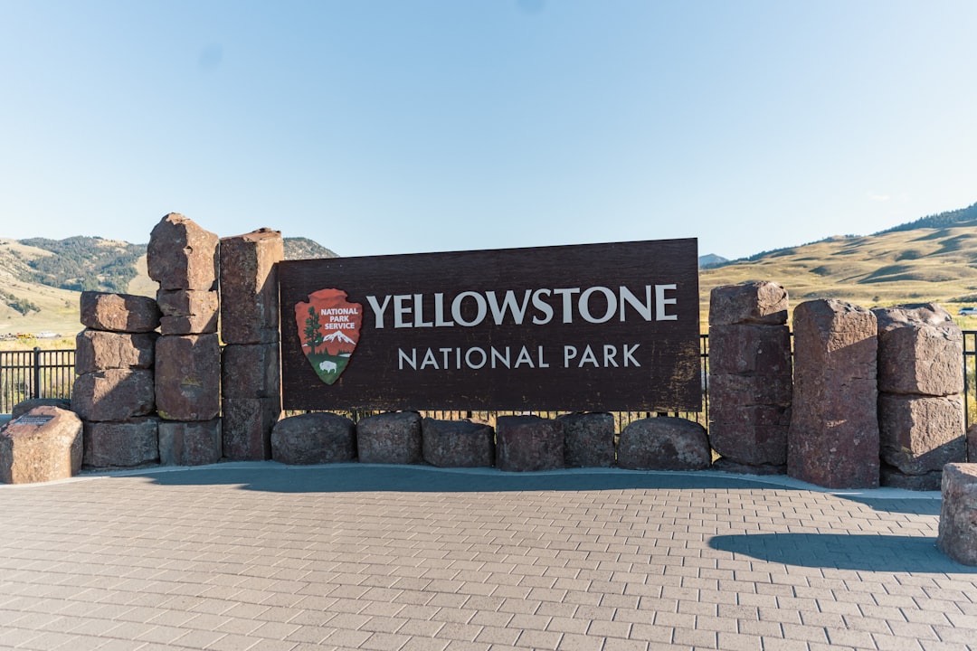 a sign for yellowstone national park on a sunny day